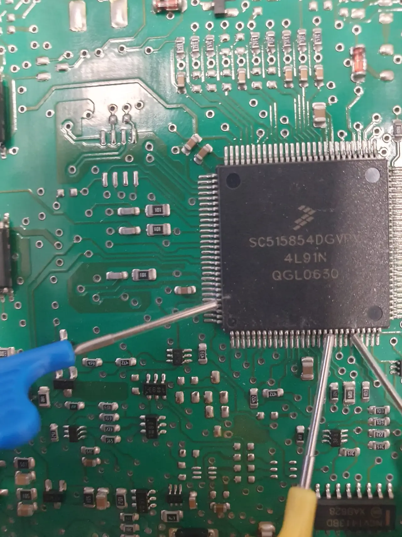 Precision electronics work on an ECU circuit board